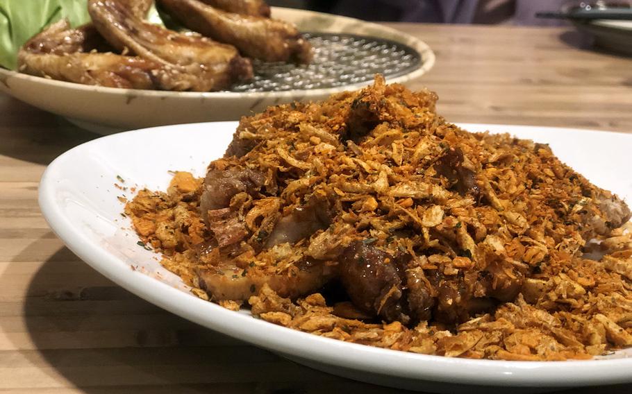 A favorite dish at Toriyoshi Shoten is the crispy yamitsuki chicken, which is pieces of chicken thigh covered with seasoned, spicy fried crisps.