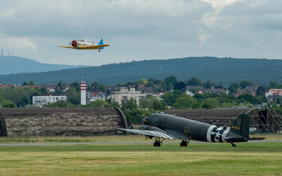 A T-6 Texan takes off as a C-47 Skytrain waits during the 70th anniversary commemoration of the end of the Berlin Airlift at Clay Kaserne airfield, Monday, June 10, 2019. 