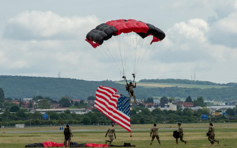 A parachutist lands with the American flag in tow during the 70th anniversary commemoration of the end of the Berlin Airlift at Clay Kaserne airfield, Monday, June 10, 2019. 