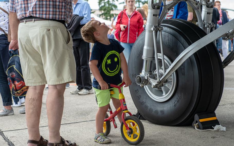 A young cyclist looks up at a C-47 Skytrain during the 70th anniversary commemoration of the end of the Berlin Airlift at Clay Kaserne airfield, Monday, June 10, 2019. 

s