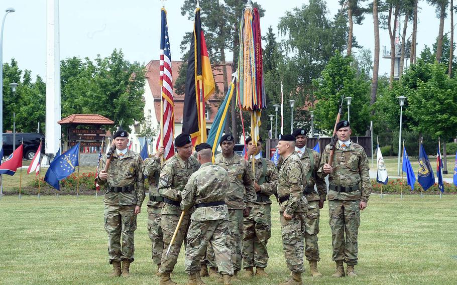 Lt. Gen. Christopher Cavoli, the commander of U.S. Army Europe, hands the 7th Army Training Command colors to Brig. Gen. Christopher Norrie, the new commander of the 7th ATC, during the change of command ceremony at Grafenwoehr, Germany, Tuesday, June 11, 2019.