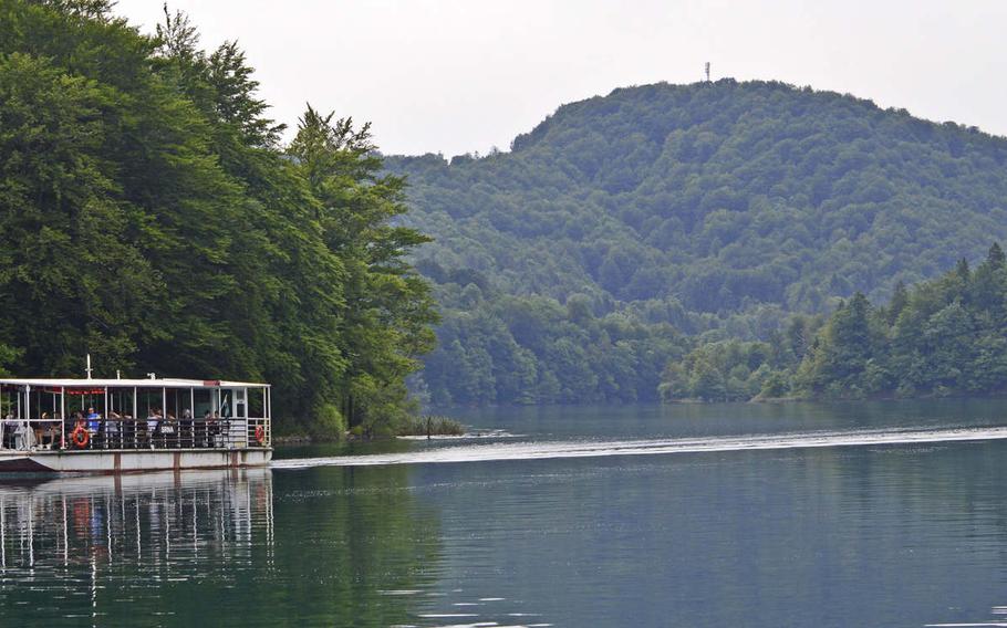 Visitors to Plitvice Lakes National Park in Croatia ride an electric boat across one of the park’s picturesque lakes. Boat rides, which can considerably cut down on the time it takes to hike around the park, are included in the price of entry tickets. 
