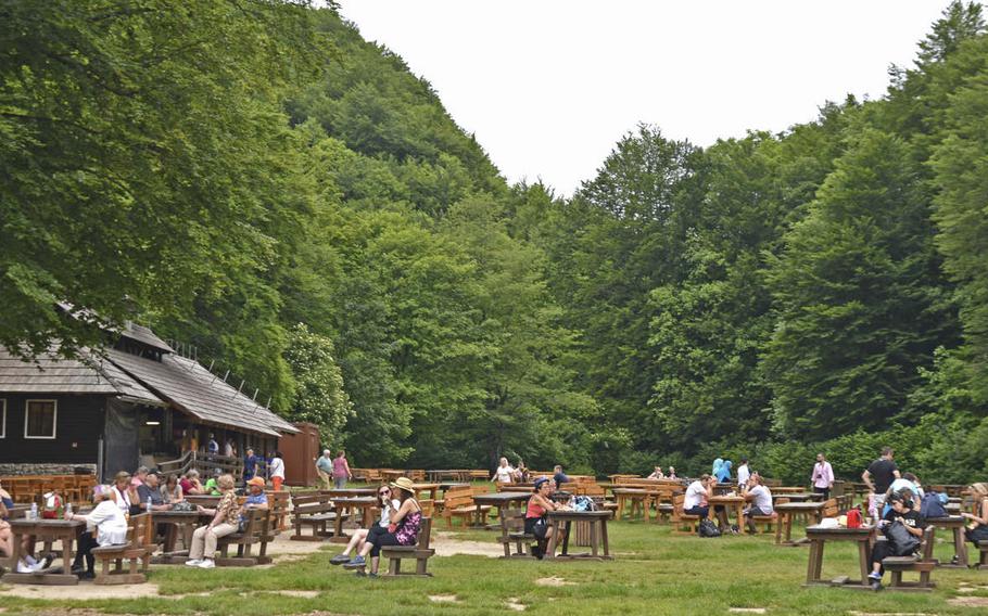 Visitors to Plitvice Lakes National Park in Croatia take a break in the main rest and picnic area of the park. In addition to outdoor seating and tables, the rest area has restaurants with indoor service, souvenir shops, ice cream stands and restrooms. 