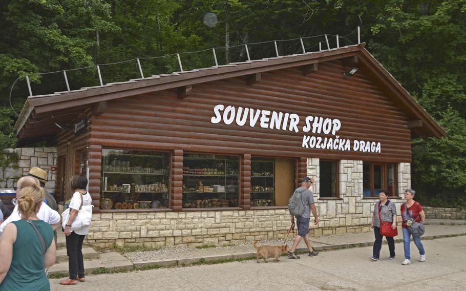 Visitors to Plitvice Lakes National Park walk past a souvenir shop located inside Croatia’s oldest and biggest national park. 