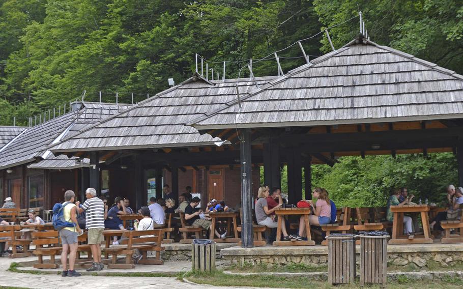 Visitors take a break at a rest area in Plitvice Lakes National Park, the largest and oldest national park in Croatia.  The park, an area of exceptional biological and geological diversity, is visited by more than a million people annually.