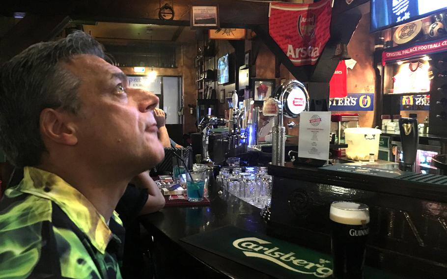 British pub fan Paul Phillips observes the decor at Fiddlers Green, a pub in the Diplomatic Area of Manama, Bahrain.