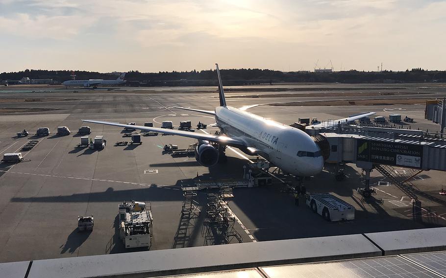 A U.S.-bound plane is parked at a gate at Narita International Airport in Japan, March 9, 2019.