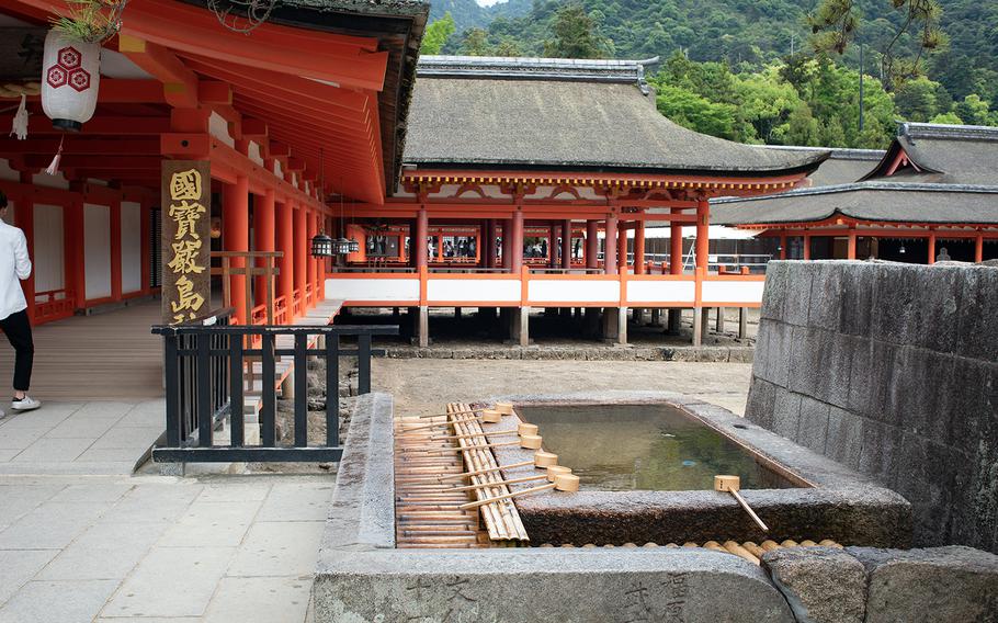 The entrance to Itsukushima Shrine at Miyajima, Japan, is a photographer's dream with its brilliant orange pillars and wooden walkways.