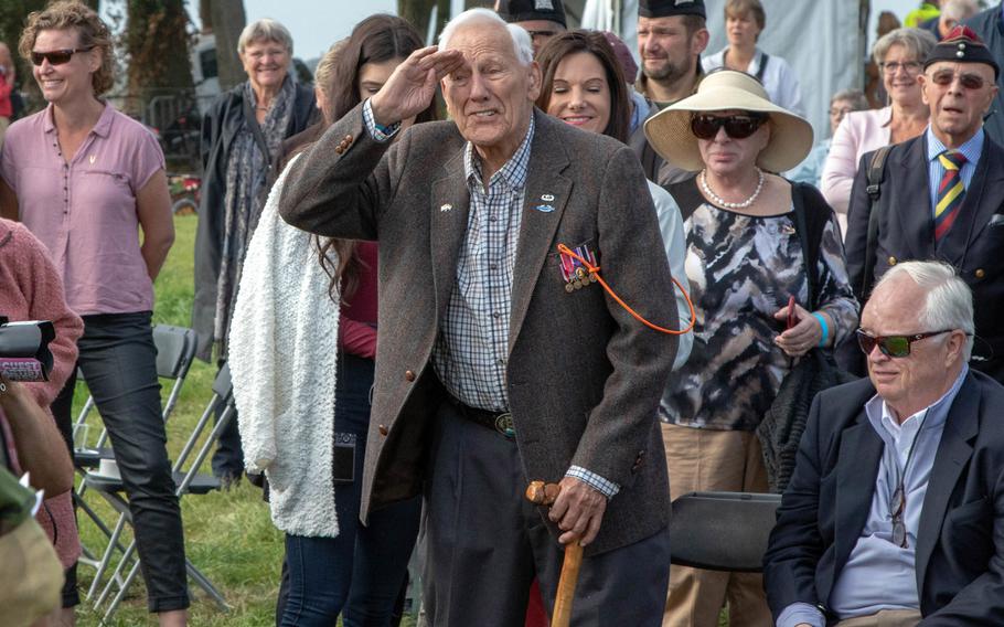 Gene Metcalfe, a World War II veteran and former POW, salutes the crowd after being awarded the Military Order of William in Groesbeek, Netherlands, Sept. 18, 2019. Sitting at right is Richard Blankenship who accepted the award on behalf of his late father, Robert C. Blankenship.