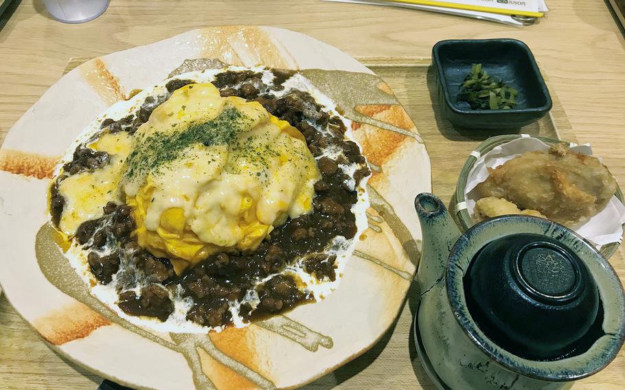 This set from Toritama in Okinawa, Japan, includes a chicken omelette on rice with a demi-glace sauce and cheese.