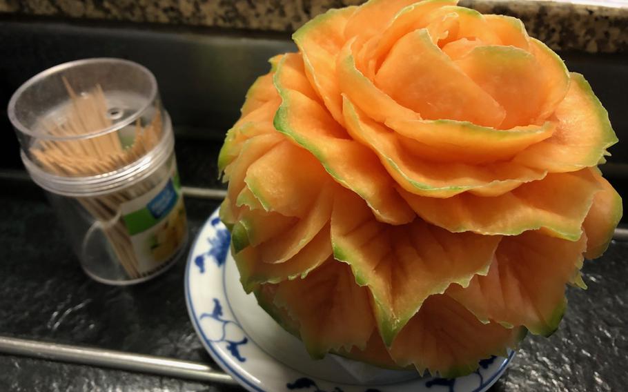 A flower carved out of a cantaloupe sits on the edge of the counter in Yoshi Nudelbar in Kaiserslautern, Germany, on Oct. 9, 2019. The melon-art was not intended for consumption.