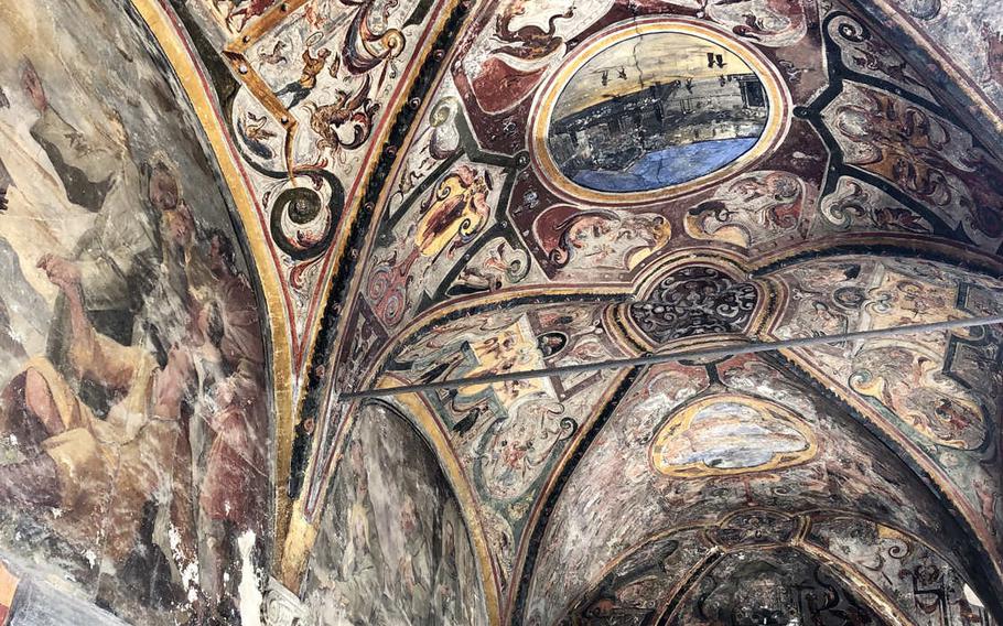 The gaudy murals covering some parts of the main cloister are a sharp contrast to the more understated Renaissance art inside the Church of Santa Maria la Nova in Naples, Italy.