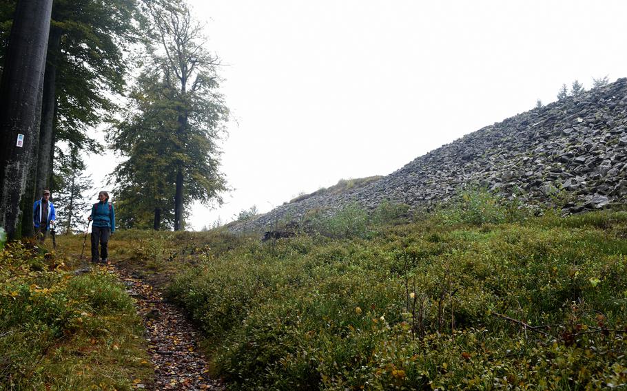 Hikers travel along a path that parallels the north side of the Celtic ring wall in Otzenhausen, Germany. The circular rampart protected an ancient Celtic settlement on top of the Dollberg hill and may have been built as early as 400 B.C.