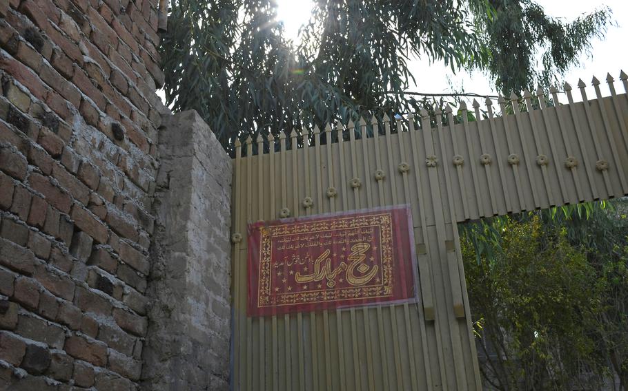 A sign to celebrate a family member???s pilgrimage to Saudi Arabia still hangs at a house in Jalalabad on Sunday, Oct. 27, 2019, nearly two months after the celebration. On the night of the celebration, a CIA-backed paramilitary group stormed the house, killing four brothers.