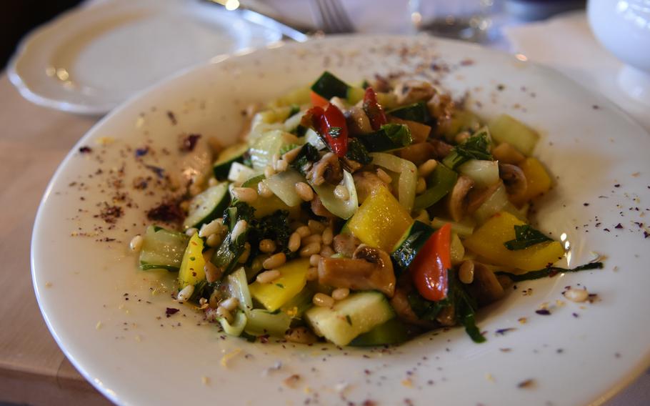 The Burgschaenke, a traditional German restaurant in Hohenecken, Germany, serves several vegetarian dishes, including this entree of sauteed vegetables, roasted pine nuts and chili peppers on a bed of noodles.