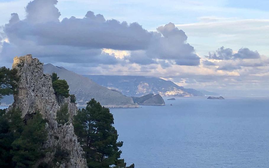 As you approach Arco Naturale on the left, you can see Capri's green, rugged hills jutting into the sea.