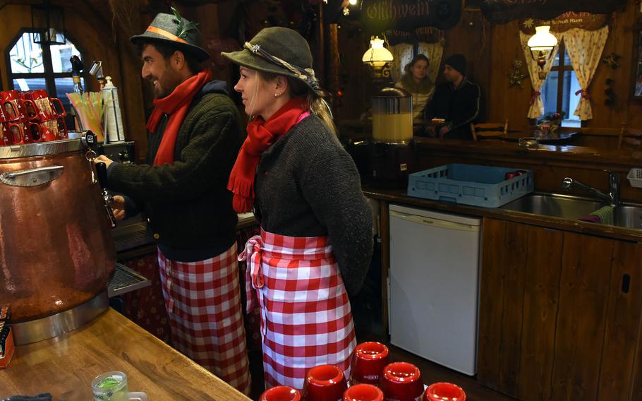 Mulled wine is served up in traditional German garb at the Christmas market in Worms, Germany.