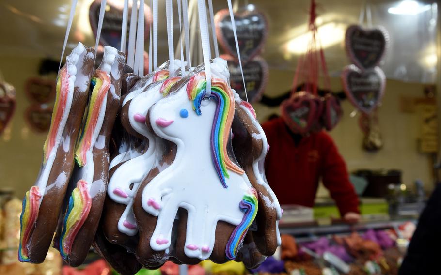 Gingerbread cookies decorated as unicorns hang from a stall at the Christmas market in Worms, Germany.