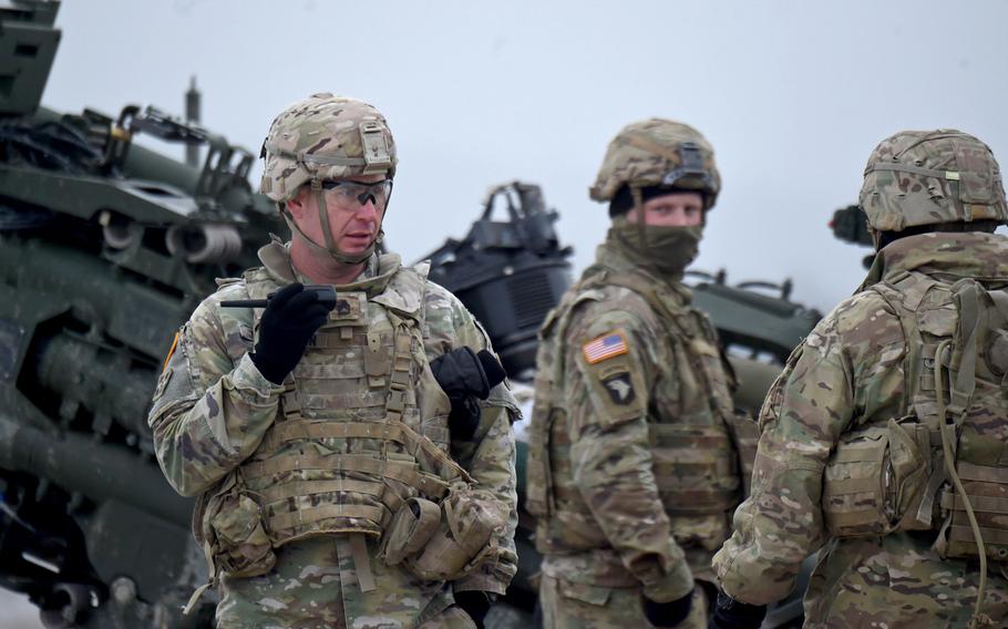 Sgt. 1st Class Rocky Johnson, left, communicates with a command center before the 2nd Cavalry Regiment conducts a live-fire exercise in Vilseck, Germany, Dec. 12, 2019.