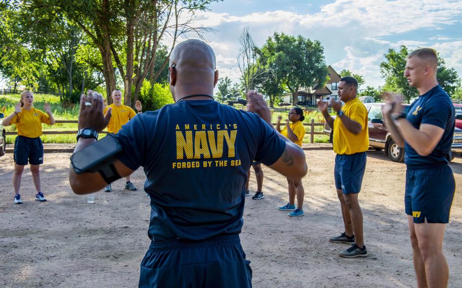 Reserve sailors at Navy Operational Support Center Fort Carson, Colo. warm up before a fun run in July 2019. Walmart must pay a Navy reservist back pay and review its hiring policies as part of a lawsuit settlement with the Department of Justice, after a store in Grand Junction, Colo., denied the reservist a seasonal, part-time job when she disclosed she would need to take two weeks off during the summer for reserves training.
