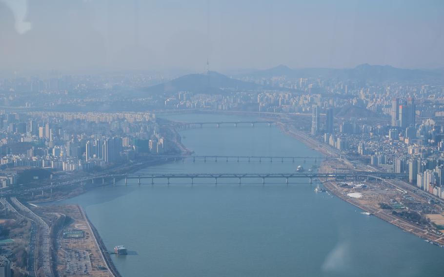 Lotte World Tower's Seoul Sky observation deck offers 360-degree views of Seoul, South Korea, including the Han River and Seoul Tower.