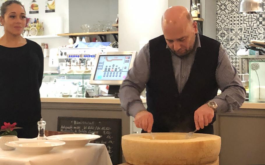 Homemade pasta is mixed in a wheel of parmesan, one of the specialties of the Italiano Sapori Veri restaurant in Kaiserslautern, Germany.