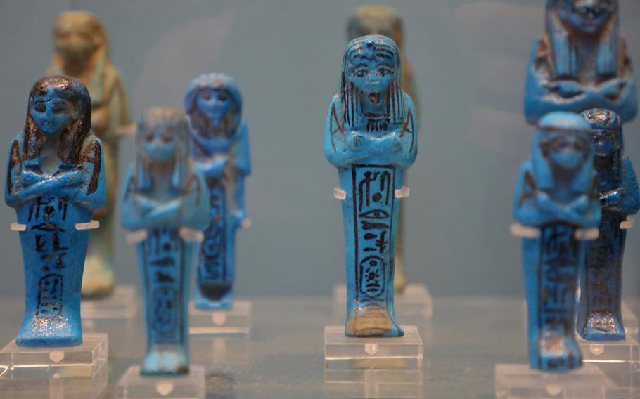 Blue glazed shabtis, or mummiform figurines about 2 inches to a foot tall, of the high priests of Amun and members of their families at the British Museum in London, England.