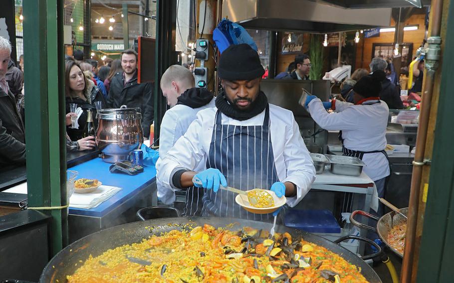 A huge dish of paella awaits customers in Borough Market in south London. The market, located near London Bridge Tube station, is easily accessible by public transportation and foot.