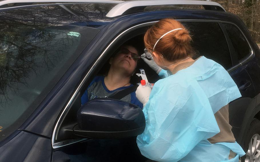 Jakawana Minton, a civilian at the U.S. Army garrison in Stuttgart, gets screened for the coronavirus at a drive-THRU site next to the health clinic on Patch Barracks March 19, 2020. Coronavirus screening at the U.S. Army garrison in Stuttgart was expanded to include symptom-free people who live in apartment buildings or work in customer service, officials said Sunday, March 23, 2020.