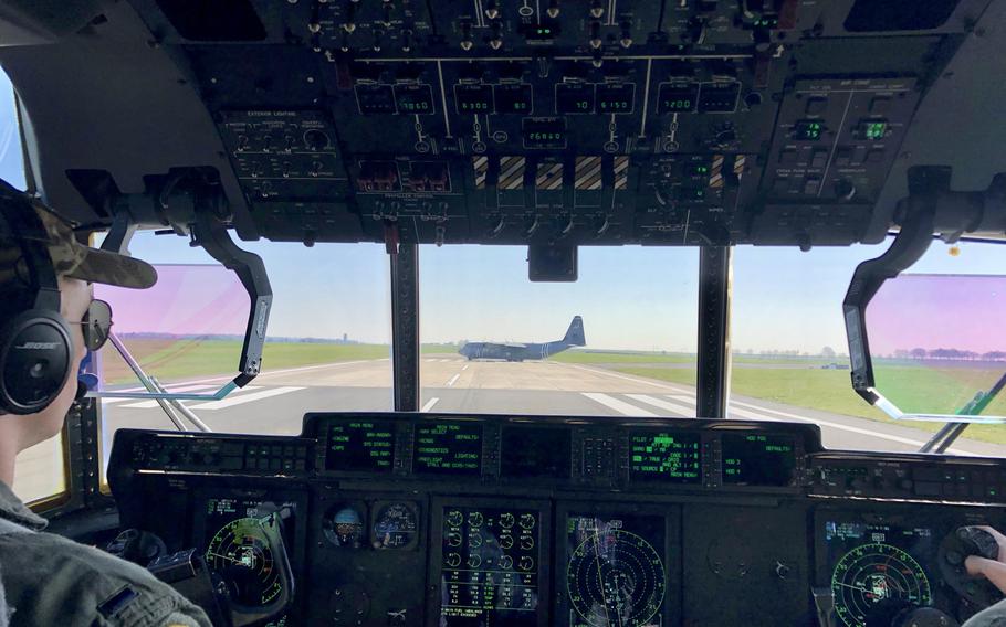 A C-130J from the 37th Airlift Squadron based at Ramstein, Germany, turns around after a formation on the runway of the NATO air base at Chievres, Belgium, in preparation for a training flight to drop supplies by parachute Thursday, March 26, 2020. The planes are painted with the same invasion stripes that the squadron's cargo planes wore when they dropped paratroopers during the D-Day invasion in June 1944.