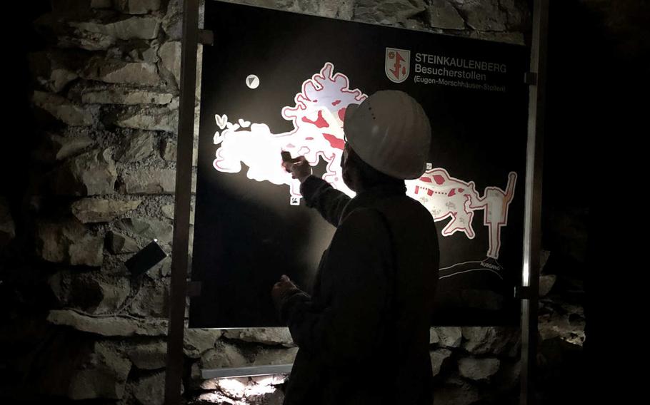 A tour guide shows the size of the Steinkaulenberg mine on a map at the entrance, in the town of Idar-Oberstein, Germany.