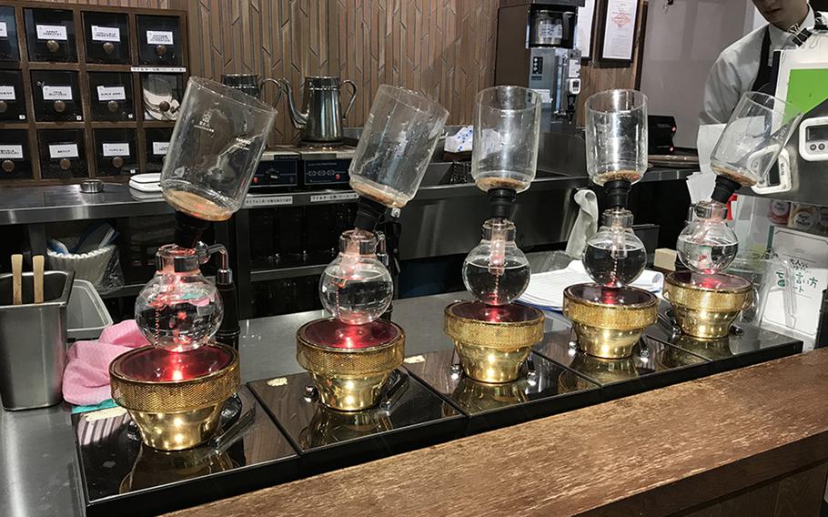 Syphon-style coffee brewers await customers' orders at Kurashiki Coffee in Sasebo, Japan.