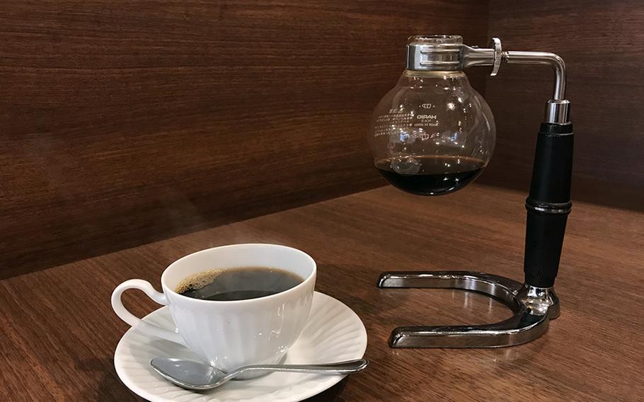 A hot, fresh cup of joe from Kurashiki Coffee in Sasebo, Japan, steams after being poured from a syphon brewing system.