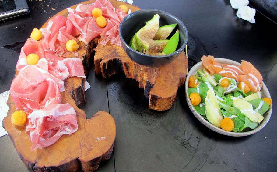 Two appetizers at the Cantina del Tormento in Vicenza make more than a meal for one. At left is prosciutto and melon, with a side of figs. Salmon, avocado and greens are to the right.