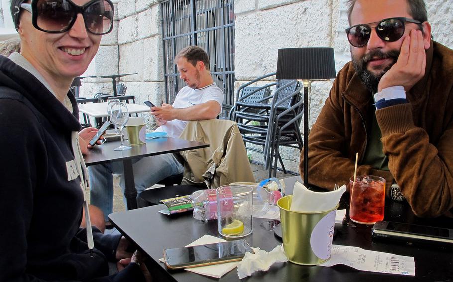 All tables at the Cantino del Tormento are outside on the Piazza delle Erbe, giving Italian patrons a reason to wear sunglasses even when it's overcast. At left is Italia. Her friend, facing the camera, is enjoying his Negroni.