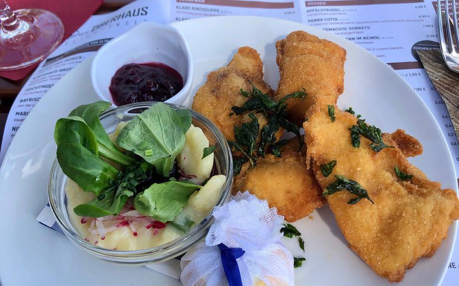 A plate of Buttermilch-Backhaehndl, or buttermilk fried chicken, at the Oberhaus restaurant in Passau, Germany. Filets of marinated chicken breast are breaded and then fried until crisp, and come served with potatoes,  salad and half a lemon.