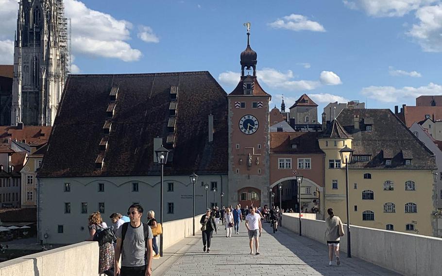 The historic Steinerne Bruecke, or Stone Bridge, in Regensburg, Germany on July 7, 2020. St. Peter's Cathedral, another city attraction, is in the background at left.