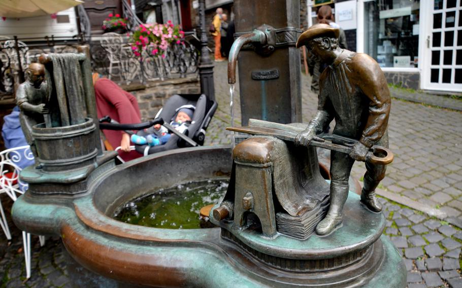 A fountain in the center of Monschau, Germany, depicts the town's past as a hub for textile production. Monschau lies near Germany's western border with Belgium, below the 100-mile Vennbahn bike path, which runs from Aachen in Germany, through Belgium, to Troisvierges in Luxembourg.