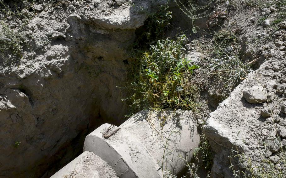 A pipe that is supposed to be carrying water away from the Makroyan Waste Water Treatment Plant lies cracked and broken, Aug. 16, 2020, due to a flash flood in March last year. Untreated sewage from the unloading station is piped into the Kabul River, instead of going to the nearby treatment facility, officials said.