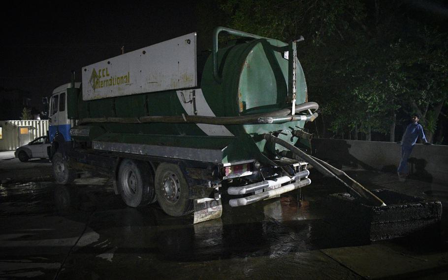 A driver dumps wastewater and sewage from his tanker truck at the Makroyan Waste Water Unloading Station in Kabul, Afghanistan, on July 20, 2020. Untreated sewage from the unloading station is piped into the Kabul River, instead of going to the nearby treatment facility, officials said.