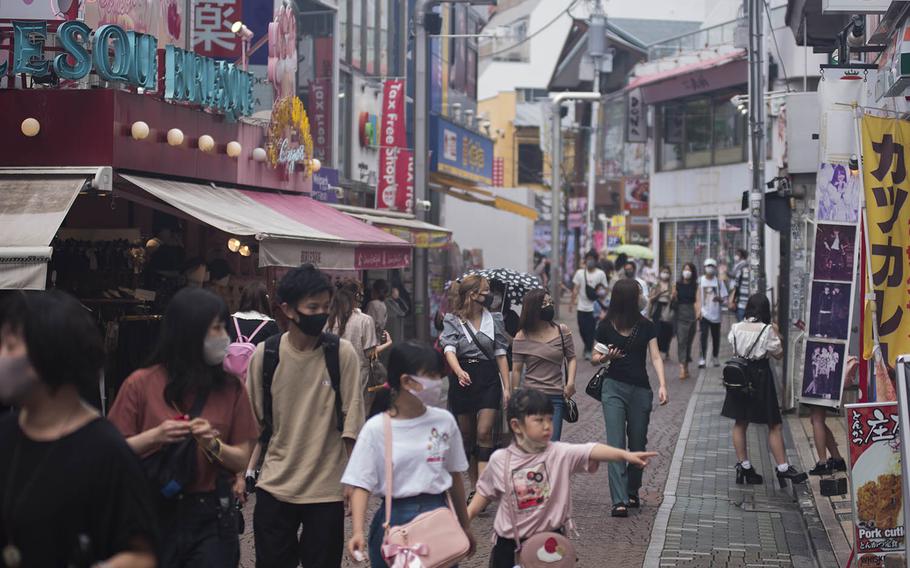 People explore Takeshita Street in the Harajuku neighborhood of central Tokyo, Sept. 6, 2020. The pedestrian shopping lane is lined with fashion boutiques, cafes and eateries.