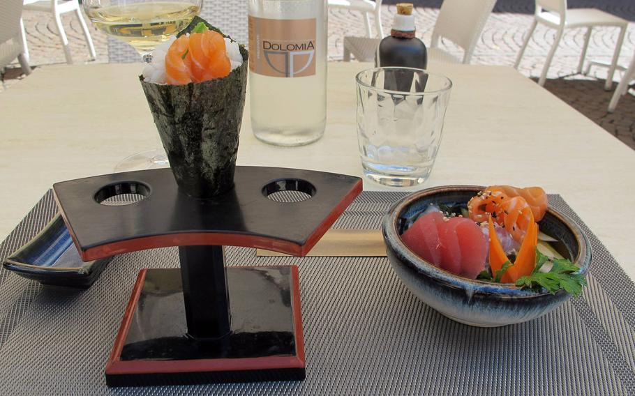 A temaki with salmon and salmon roe, left, and a seafood sunomono with salmon, tuna, white fish, cucumber, seaweed and sesame seeds made for delicious appetizers at a recent visit to Furai Japanese Restaurant in Vicenza.