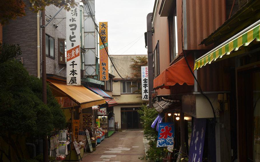 Visitors can shop and eat at the small village that sits along the journey to the top of Mount Mitake, Japan.