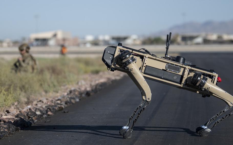 Tech. Sgt. John Rodriguez, 321st Contingency Response Squadron security team, patrols with a Ghost Robotics Vision 60 prototype during an exercise on Nellis Air Force Base, Nev., Sept. 3, 2020. Air Force scientists are exploring how humans will interact with artificial intelligence systems when they behave independently.