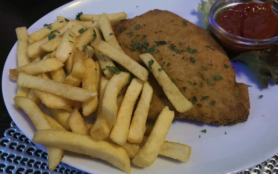 The kids' schnitzel at Asteria in Kaiserslautern, Germany, is a large portion with a choice of a side dish.
