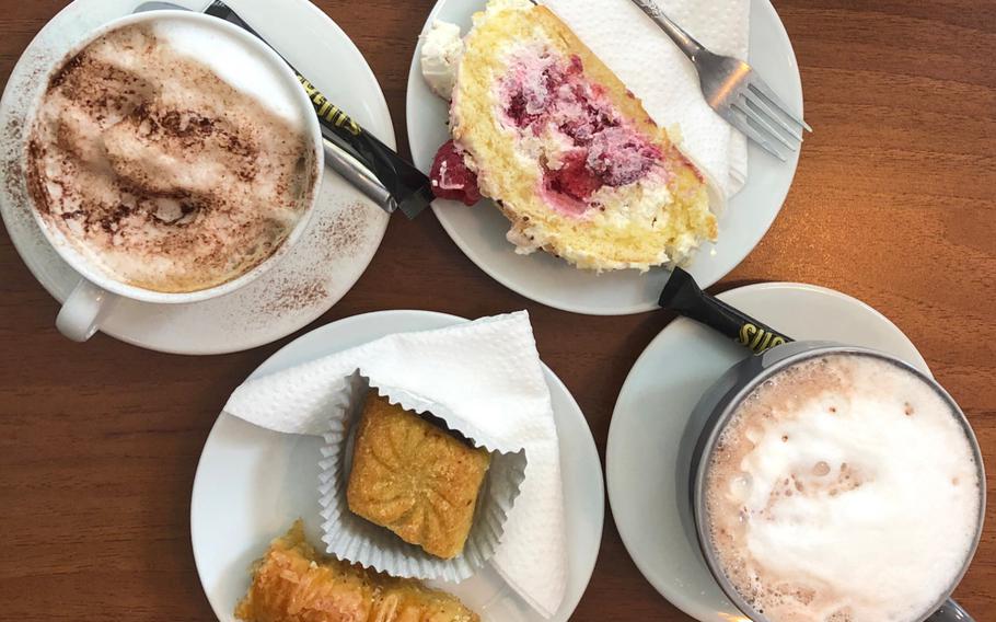 From left to right: a cappuccino, North African pastries, a raspberry sponge cake and a hot chocolate wait to be tucked into at Au Cafe des Delices in Sarreguemines, France, on Oct. 3, 2020.