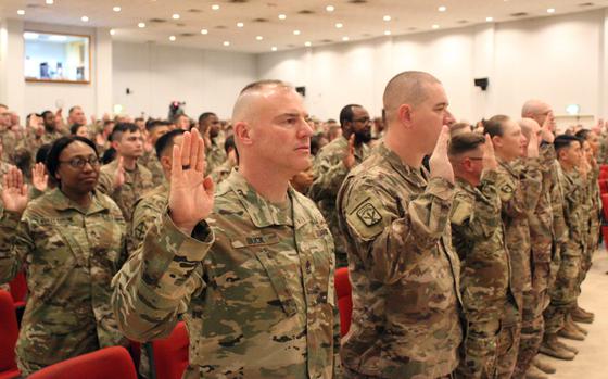 First Sgt. Joseph N. Buck Jr., 1173rd Deployment and Distribution Support Battalion, 595th Transportation Brigade, recites the noncommissioned officer creed alongside other soldiers during an NCO induction ceremony at Camp Arifjan, Kuwait, Feb. 9, 2019. Many NCOs, primarily in the ranks from staff sergeant through master sergeant, will be able to rank their desired next assignments under a new program.  

