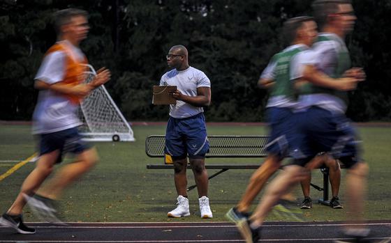 Senior Airman David Lawal monitors airmen during the 1.5-mile run of the U.S. Air Force Fitness Test at Hurlburt Field, Fla., Aug. 24, 2017. An Air Force Spark Tank proposal uploaded on Oct. 16, 2020, looks to eliminate the Air Force fitness test and replace it with monitored monthly fitness requirements. 

