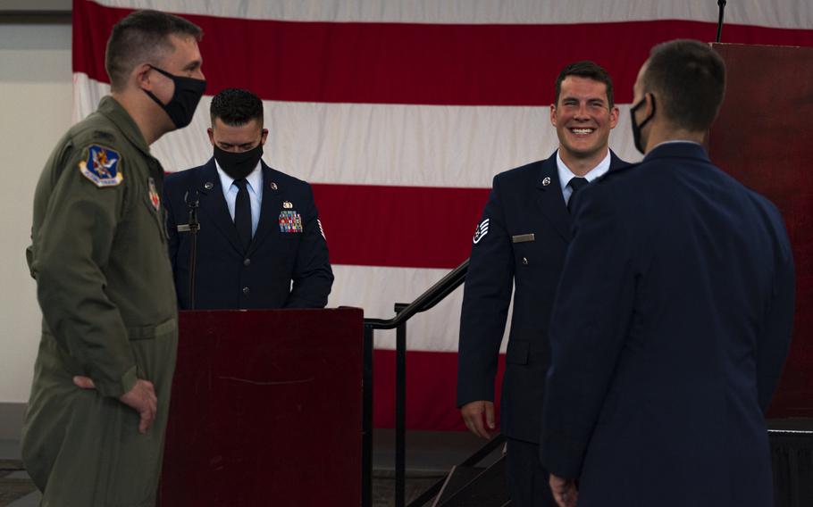 Airmen assigned to the 23rd Wing talk with Staff Sgt. Nicholas Brunetto, a pararescueman with the 38th Rescue Squadron, after he received a Silver Star Medal during a ceremony at Moody Air Force Base, Ga., on Oct. 29, 2020.