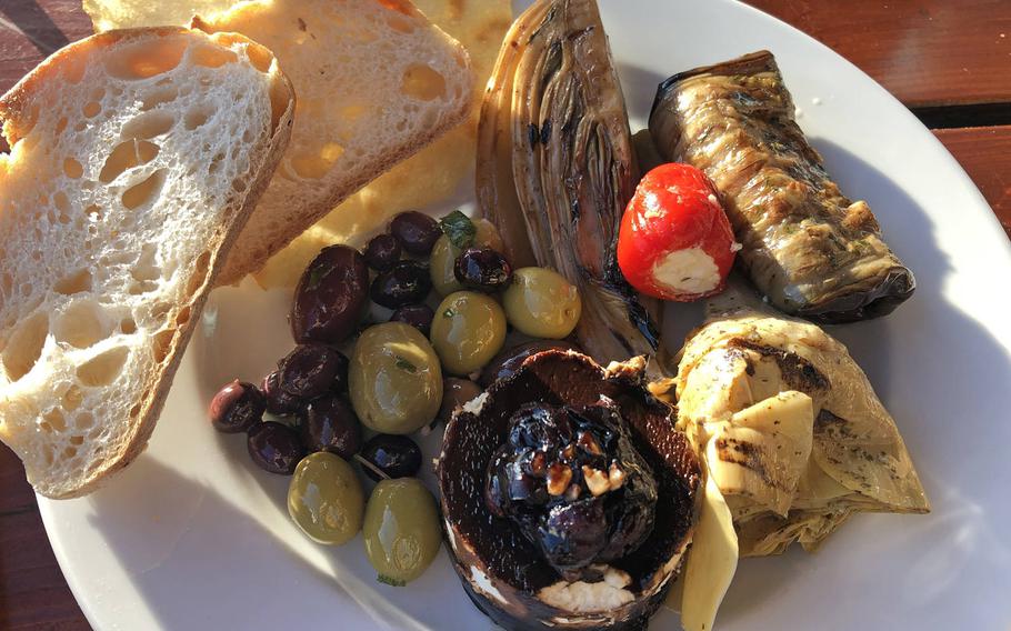 An antipasti plate at Vinocentral in Darmstadt, Germany. This one includes olives, fennel, grilled, marinated eggplant, an artichoke heart and goat cheese topped with balsamic cream and cranberries.